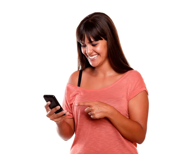 Young woman pointing and looking to mobile — Stock Photo, Image