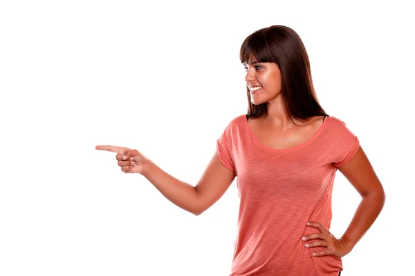 Charming young woman pointing to her right — Stock Photo, Image