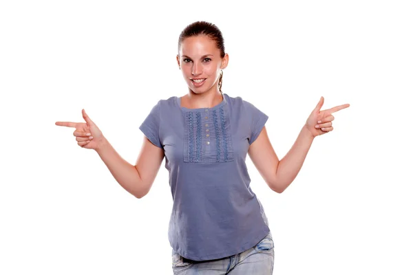 Smiling young woman looking at you pointing — Stock Photo, Image