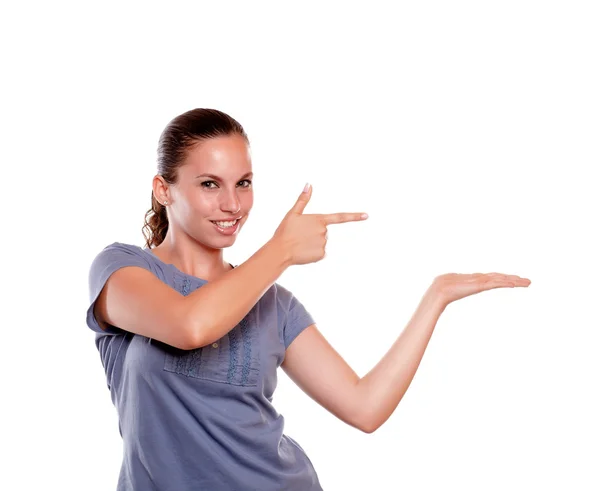 Young female pointing and holding out her hand — Stock Photo, Image