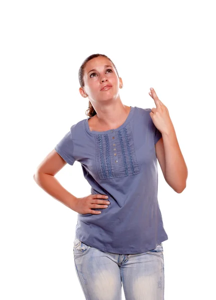 Young woman looking up and crossing her fingers — Stock Photo, Image