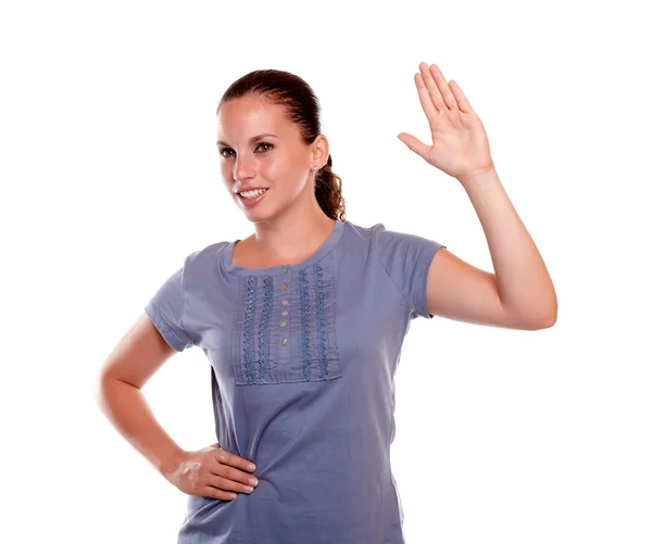 Smiling young female greeting to the left — Stock Photo, Image