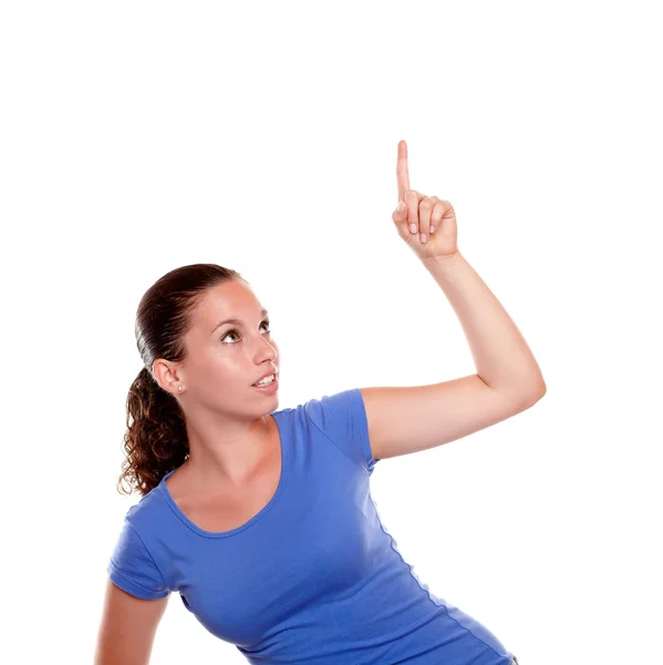 Pretty young woman pointing and looking up — Stock Photo, Image