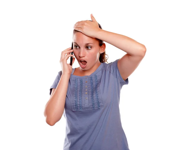 Surprised young female speaking on mobile phone — Stock Photo, Image