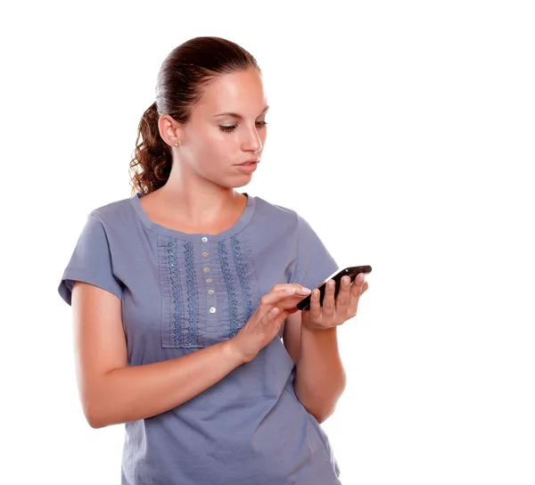 Pretty young female sending message by cellphone — Stock Photo, Image