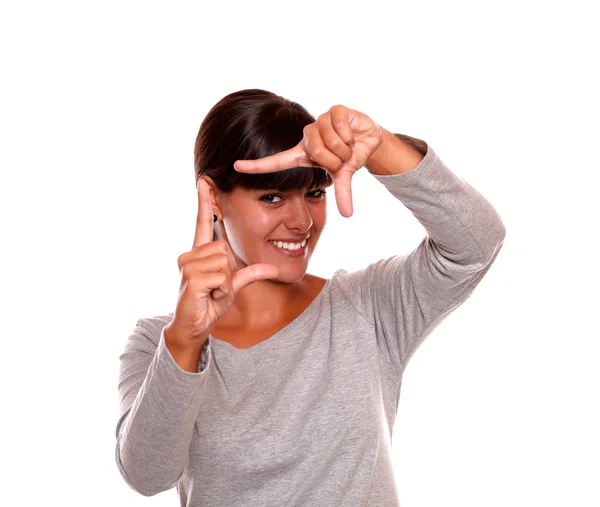 Smiling young female making frame shape with hand — Stock Photo, Image