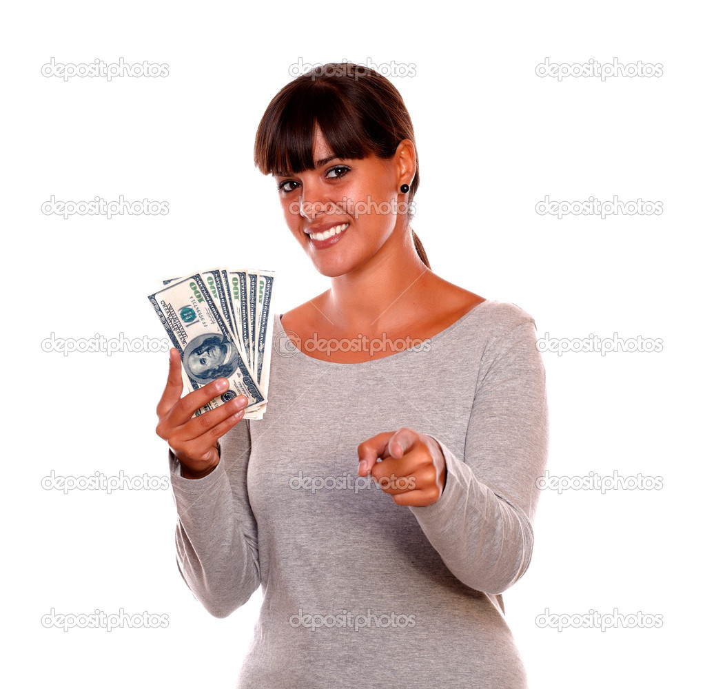 Smiling young woman with money pointing at you