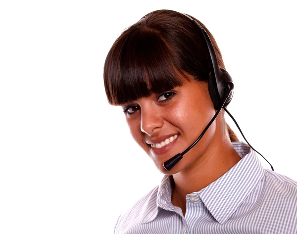 Smiling secretary using earphone looking at you — Stock Photo, Image