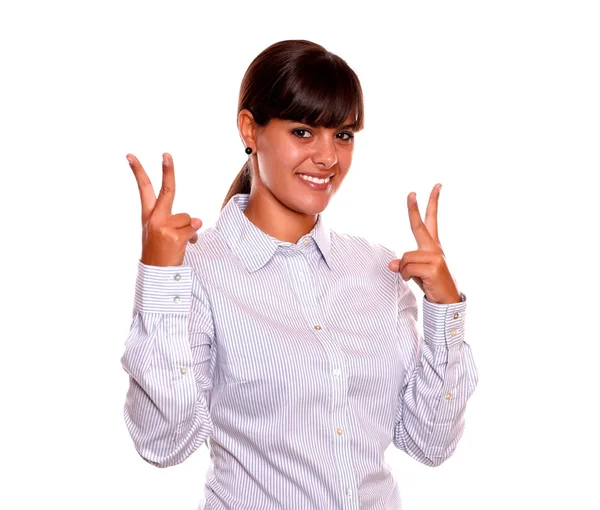 Young woman holding up two fingers in victory sign — Stock Photo, Image