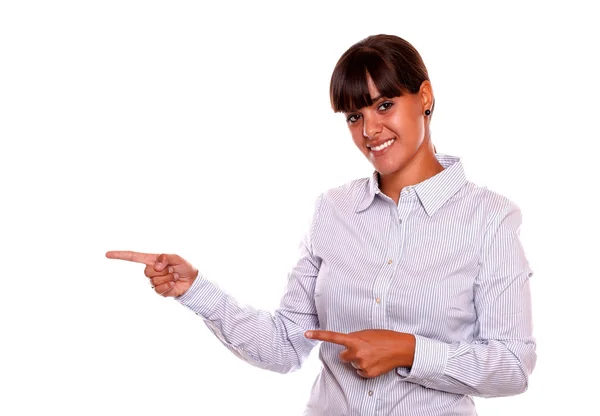 Smiling young female pointing to her right — Stock Photo, Image