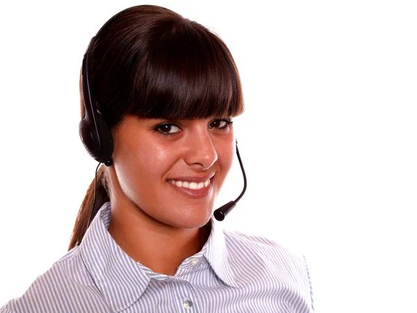 Smiling receptionist using earphone looking at you — Stock Photo, Image