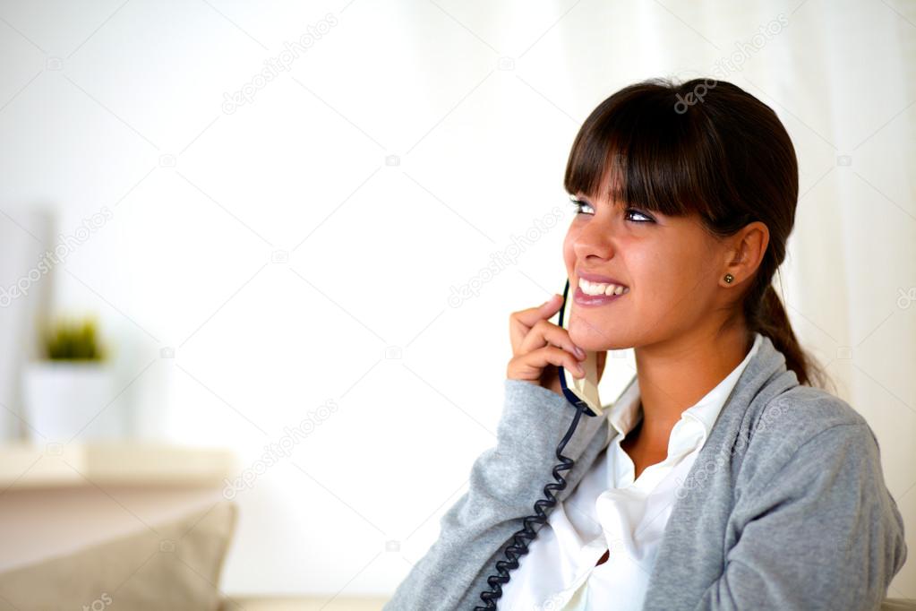 Smiling woman speaking on phone looking right