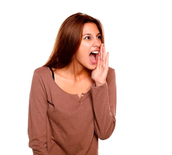 Charming young woman screaming to her left — Stock Photo, Image