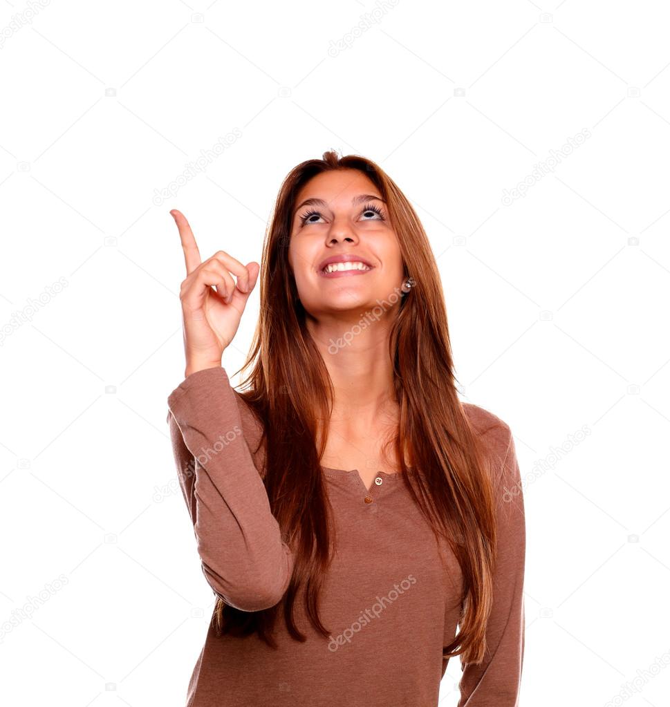 Smiling young woman pointing and looking up