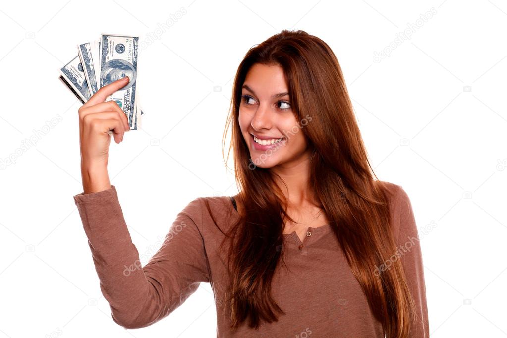 Young woman looking to right hand with cash money