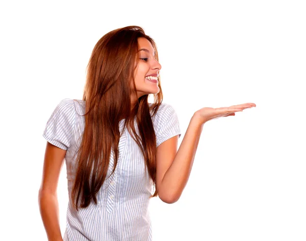 Smiling young woman holding out her palm — Stock Photo, Image