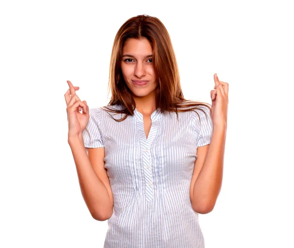 Pensive young female crossing her fingers Stock Photo