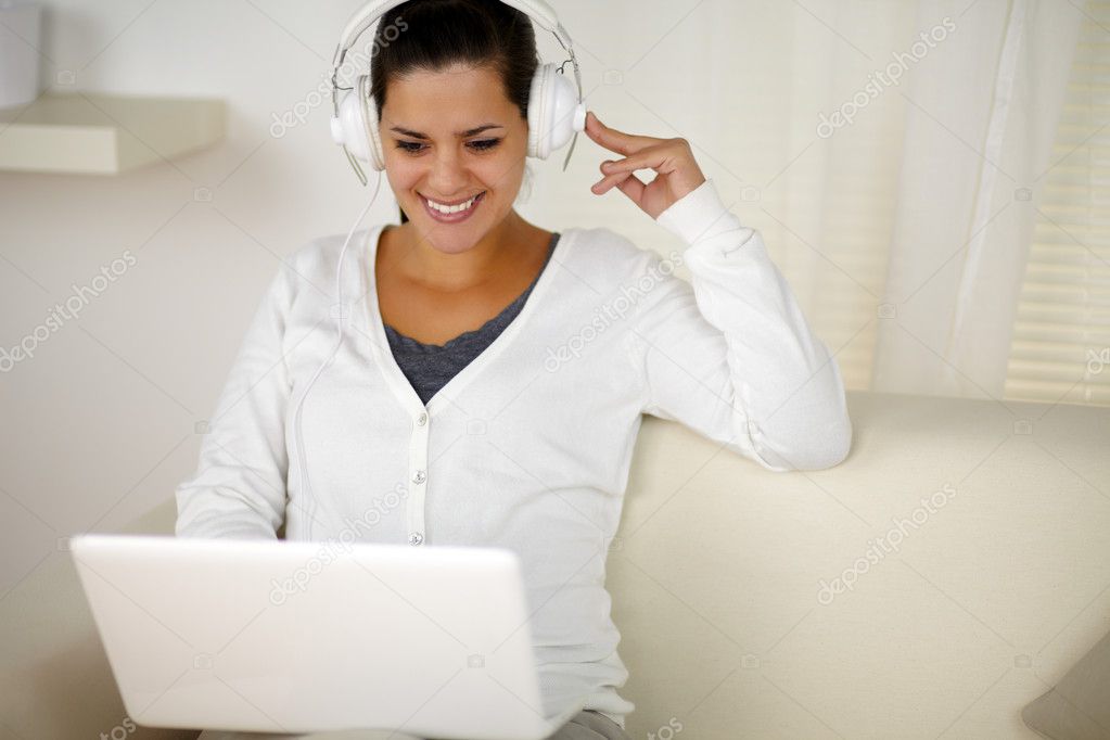 Charming woman with headphone listening music