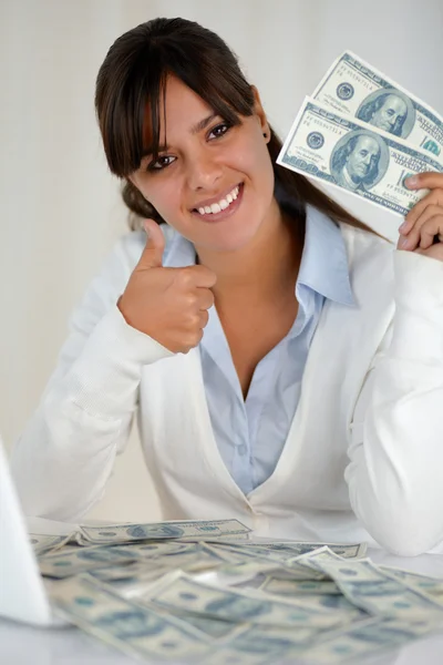 Young woman looking at you holding cash dollars — Stock Photo, Image