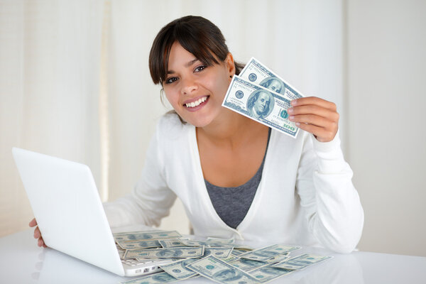 Smiling young woman showing you cash money