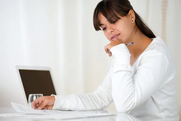 Charming young woman reading documents at office — Stock Photo, Image