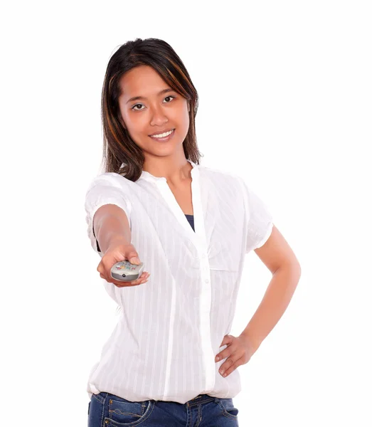 Charming young woman pointing with remote control — Stock Photo, Image