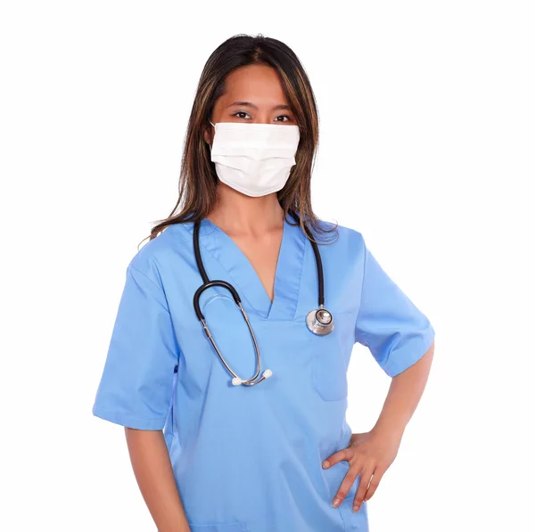 Ethnic nurse woman looking at you with a mask — Stock Photo, Image