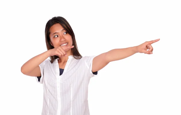 Asiatic young woman looking and pointing to left — Stock Photo, Image