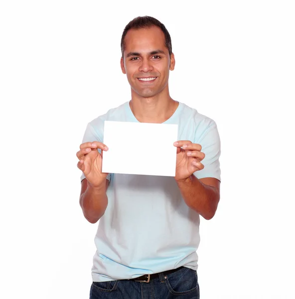 Smiling latin man holding a white card — Stock Photo, Image