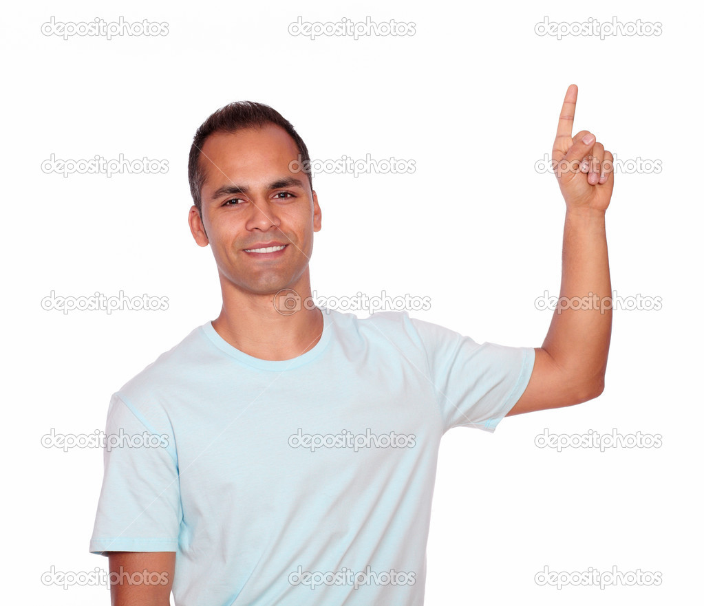Attractive young man pointing up copyspace