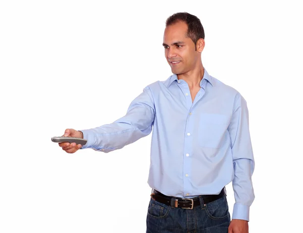 Charming adult man pointing with remote control — Stock Photo, Image