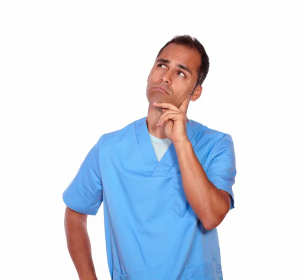 Pensive male nurse standing with hand on chin — Stock Photo, Image