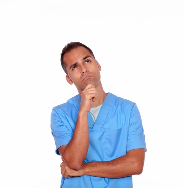 Pensive boy nurse standing with hand on chin — Stock Photo, Image