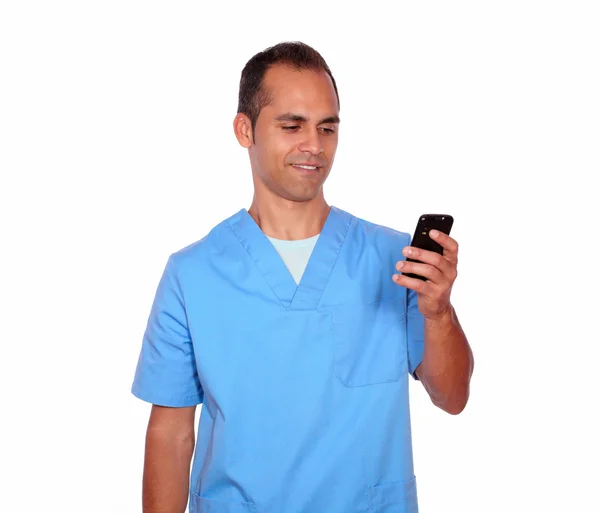 Smiling young nurse sending message on cellphone — Stock Photo, Image