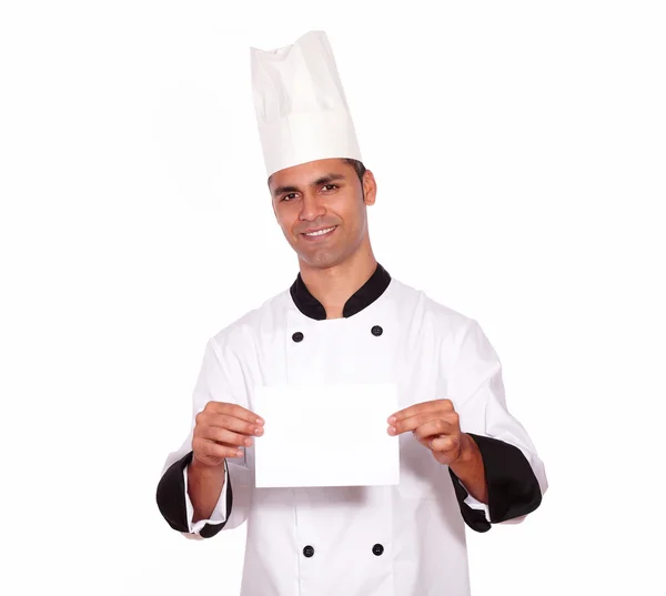 Charming male chef holding a white card — Stock Photo, Image
