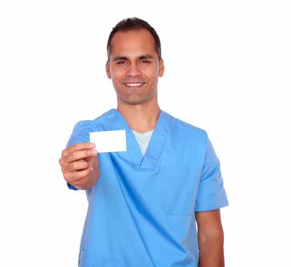 Smiling guy nurse holding up a white business card — Stock Photo, Image