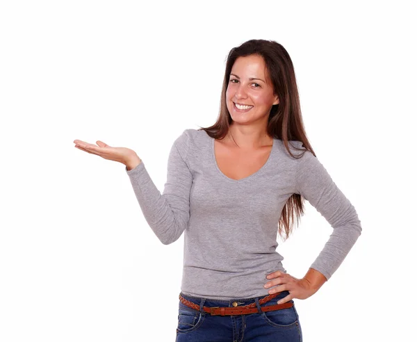 Charming female holding palm up smiling at you — Stock Photo, Image