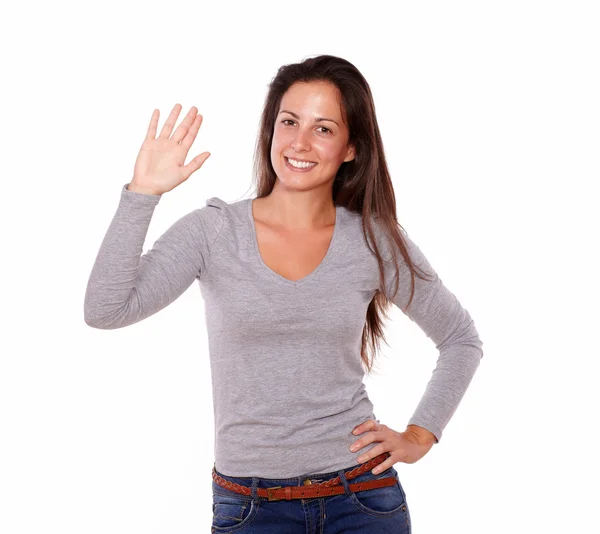 Smiling woman showing greeting gesture with hand — Stock Photo, Image