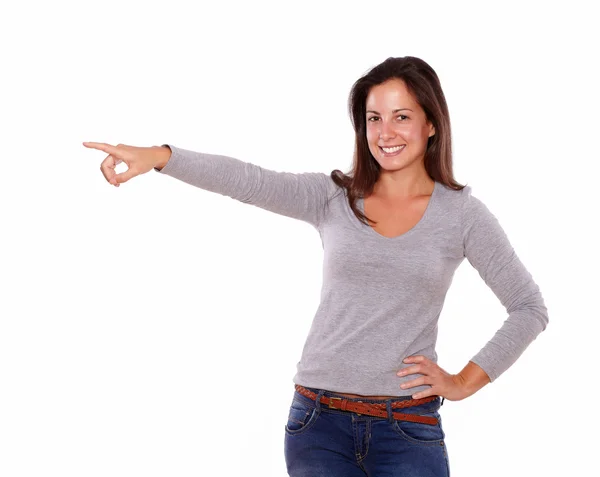 Smiling lady pointing to her right looking at you — Stock Photo, Image