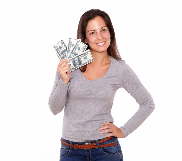 Mujer encantadora sosteniendo dólares mientras está de pie Imágenes de stock libres de derechos