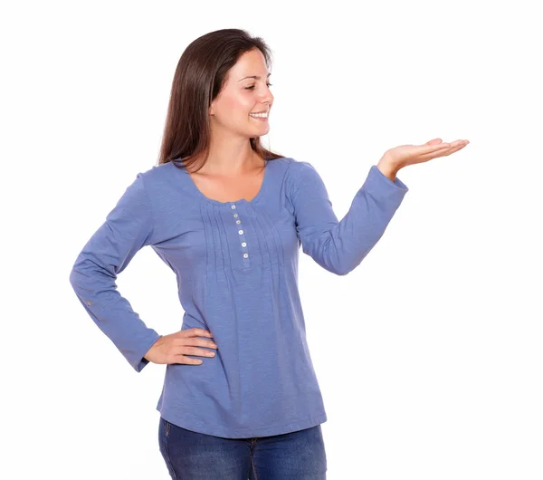 Smiling woman holding palm up while standing — Stock Photo, Image