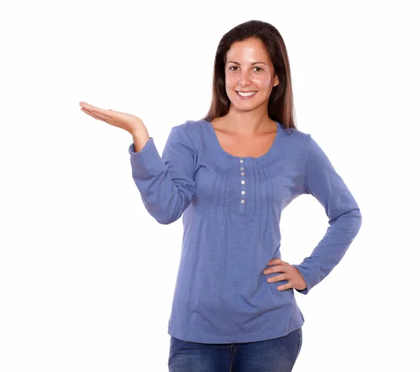 Smiling lady holding palm up while standing — Stock Photo, Image