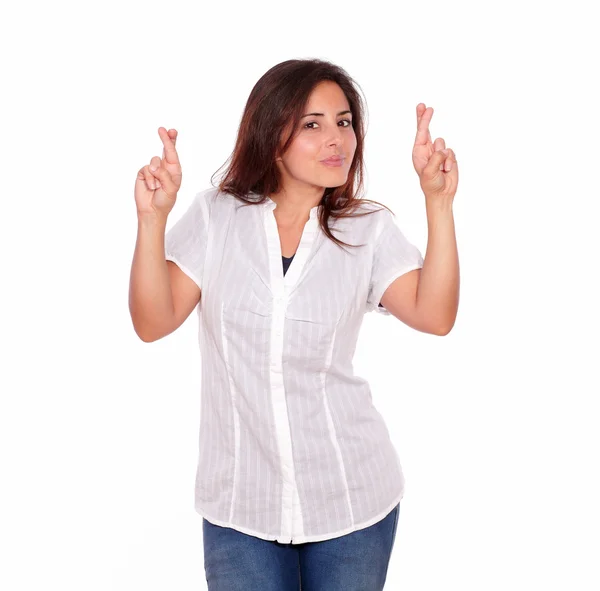 Charming woman in jeans crossing fingers — Stock Photo, Image