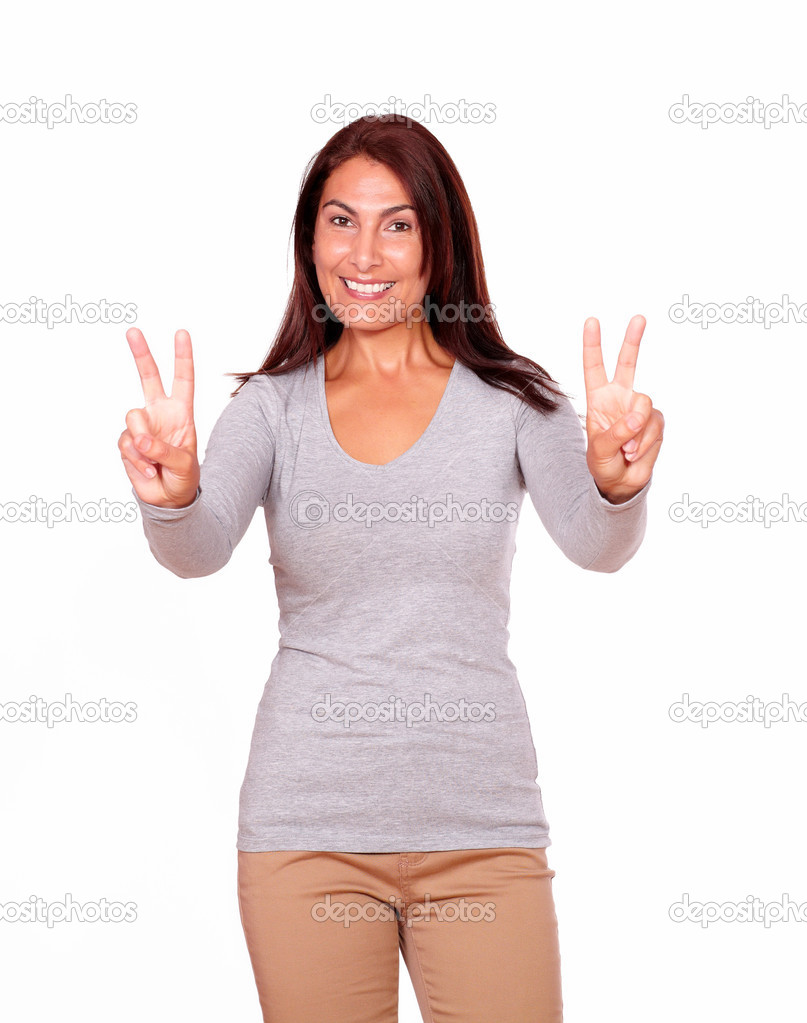 Mature woman gesturing victory sign with fingers