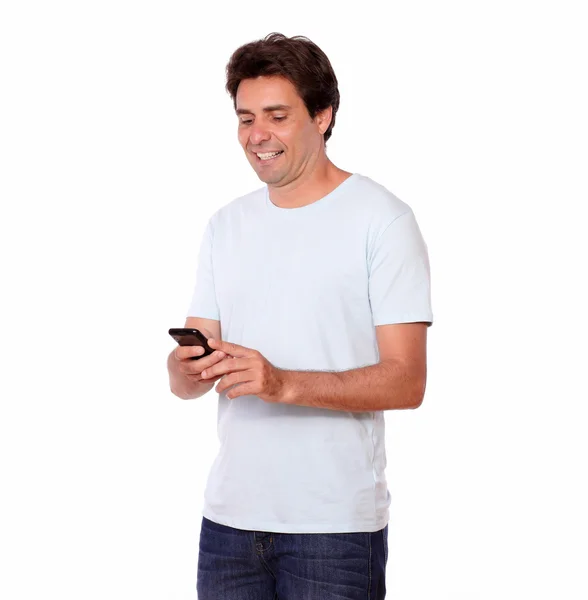 Charming guy sending a message on cellphone — Stock Photo, Image