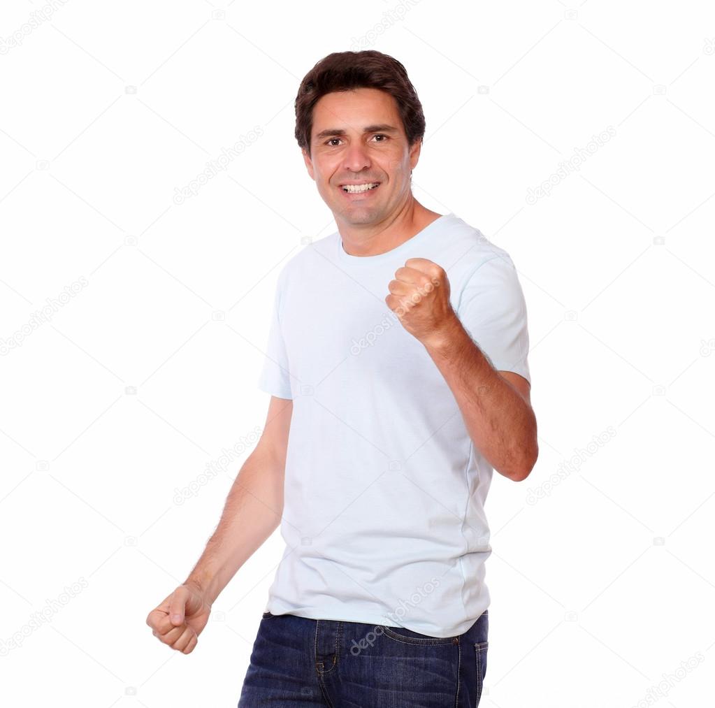 Cheerful guy celebrating victory while standing