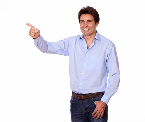 Charming male pointing to his right while standing — Stock Photo, Image