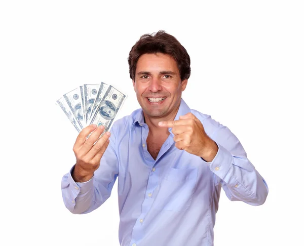 Smiling man holding and pointing cash dollars — Stock Photo, Image