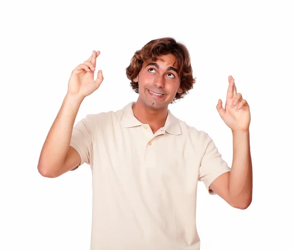 Attractive man crossing fingers while looking up — Stock Photo, Image