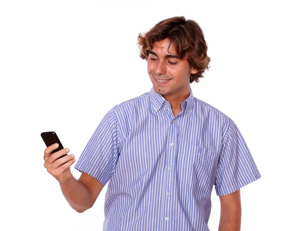 Man in blue shirts smiles while reading text. — Stock Photo, Image